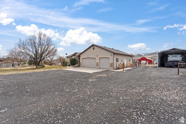 7217 W Mccuiston Ave S, Herriman, UT 84096 - view of front of house with driveway, an attached garage, stucco siding, and a carport