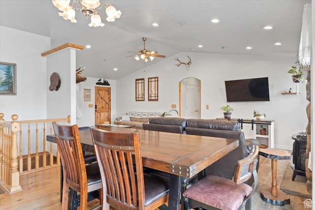 7217 W Mccuiston Ave S, Herriman, UT 84096 - dining area featuring lofted ceiling, recessed lighting, ceiling fan with notable chandelier, arched walkways, and light wood-style floors