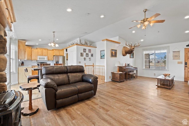 7217 W Mccuiston Ave S, Herriman, UT 84096 - living area featuring lofted ceiling, light wood-type flooring, recessed lighting, and ceiling fan with notable chandelier