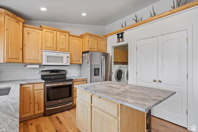 7217 W Mccuiston Ave S, Herriman, UT 84096 - kitchen featuring light brown cabinets, independent washer and dryer, and stainless steel appliances
