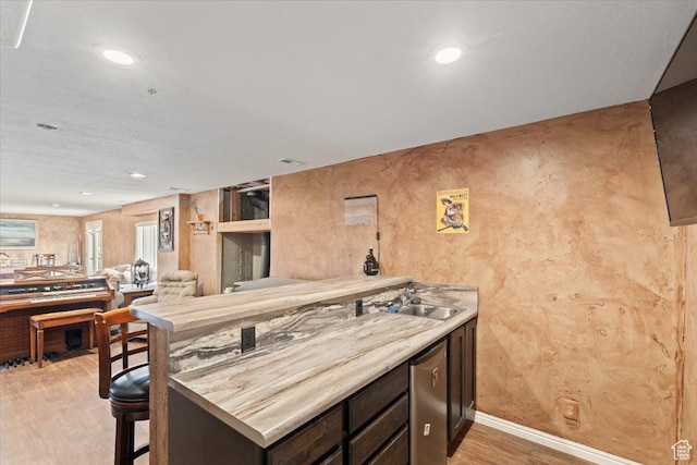 7217 W Mccuiston Ave S, Herriman, UT 84096 - kitchen with light wood-style flooring, a peninsula, dishwasher, recessed lighting, and a sink
