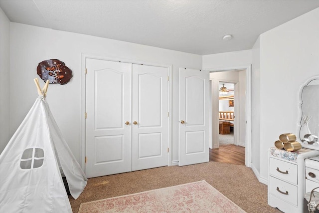 7217 W Mccuiston Ave S, Herriman, UT 84096 - bedroom featuring baseboards, a closet, light colored carpet, and a textured ceiling
