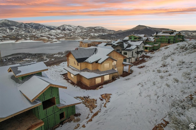 snowy aerial view featuring a mountain view