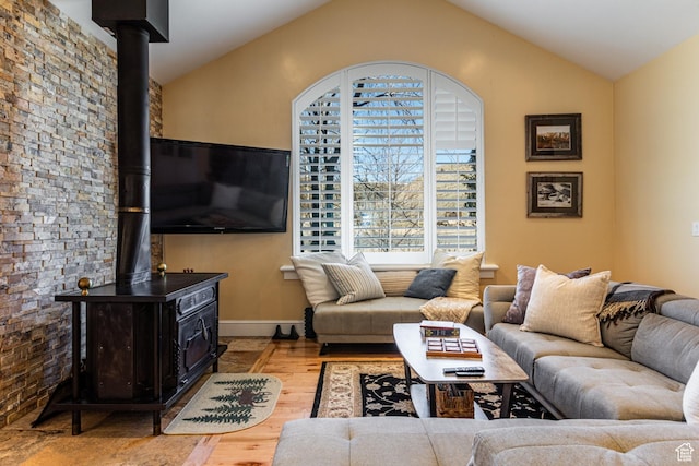 2503 W State Road 32, Peoa, UT 84061 - living area with baseboards, vaulted ceiling, a wood stove, and wood finished floors