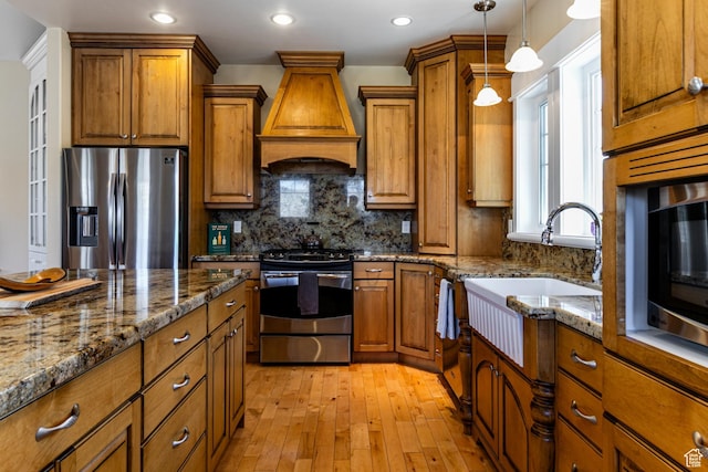 2503 W State Road 32, Peoa, UT 84061 - kitchen with pendant lighting, appliances with stainless steel finishes, custom exhaust hood, and brown cabinets