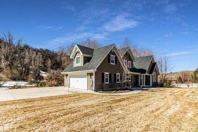 2503 W State Road 32, Peoa, UT 84061 - view of front facade with a shingled roof, a front lawn, and concrete driveway