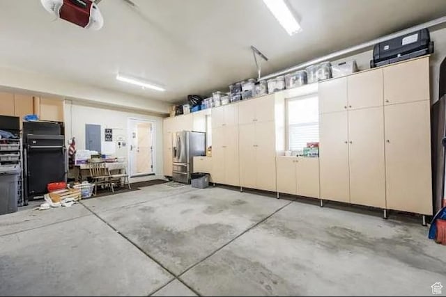 2503 W State Road 32, Peoa, UT 84061 - garage featuring stainless steel fridge with ice dispenser, electric panel, and a garage door opener