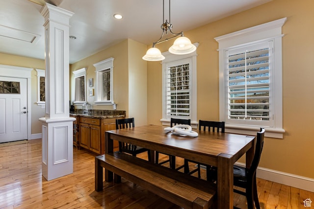 2503 W State Road 32, Peoa, UT 84061 - dining space with baseboards, decorative columns, and light wood-style floors