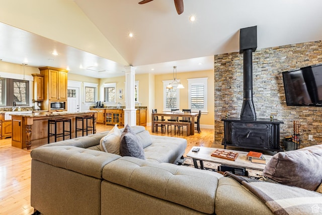 2503 W State Road 32, Peoa, UT 84061 - living room with light wood-type flooring, high vaulted ceiling, ceiling fan, and a wood stove