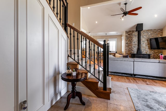 2503 W State Road 32, Peoa, UT 84061 - stairs featuring stone finish floor, ceiling fan, a wood stove, and vaulted ceiling