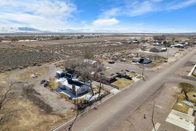birds eye view of property featuring view of desert and a mountain view