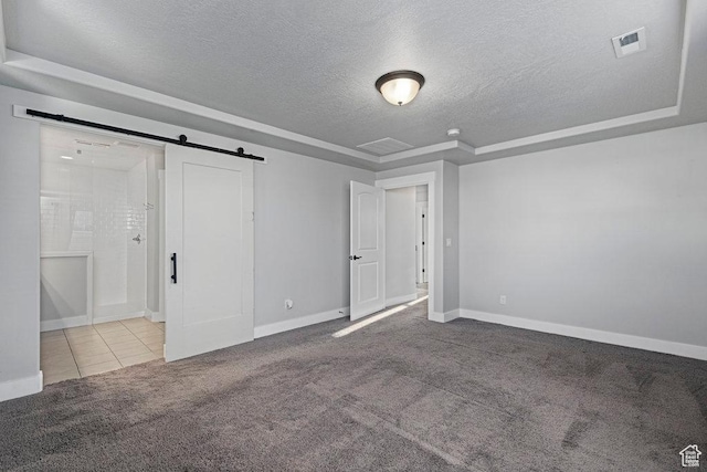 1146 W 1875 S, Syracuse, UT 84075 - unfurnished bedroom with a barn door, a textured ceiling, carpet, baseboards, and visible vents