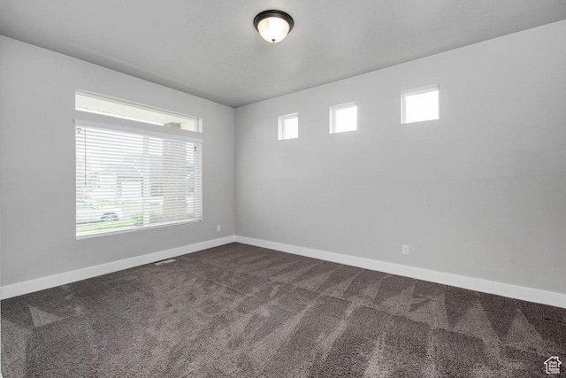 1146 W 1875 S, Syracuse, UT 84075 - unfurnished room featuring baseboards, dark carpet, and a wealth of natural light