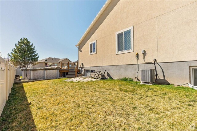 6403 W Muzzle Loader Dr, Herriman, UT 84096 - view of yard with central AC, a covered pool, and a fenced backyard