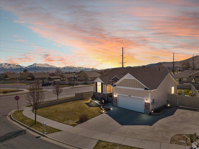 6403 W Muzzle Loader Dr, Herriman, UT 84096 - view of front facade featuring concrete driveway, board and batten siding, a mountain view, a garage, and a residential view