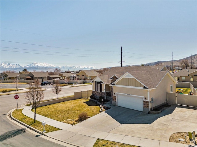 6403 W Muzzle Loader Dr, Herriman, UT 84096 - view of front facade featuring driveway, board and batten siding, an attached garage, a mountain view, and a residential view