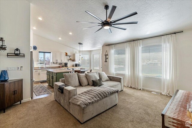 6403 W Muzzle Loader Dr, Herriman, UT 84096 - living room featuring light carpet, a ceiling fan, and a textured ceiling