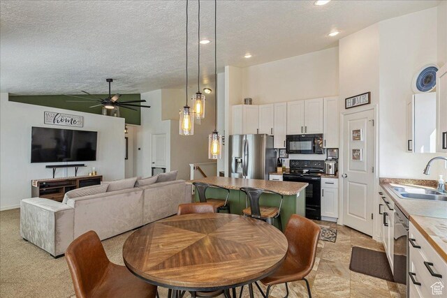 6403 W Muzzle Loader Dr, Herriman, UT 84096 - dining area with high vaulted ceiling, a ceiling fan, and a textured ceiling