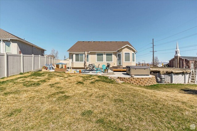 6403 W Muzzle Loader Dr, Herriman, UT 84096 - back of house with a fenced backyard, a yard, a hot tub, and a patio area