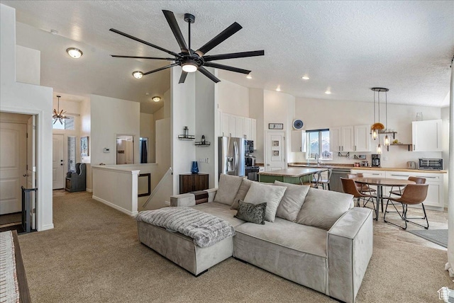6403 W Muzzle Loader Dr, Herriman, UT 84096 - living room with high vaulted ceiling, light carpet, a ceiling fan, and a textured ceiling