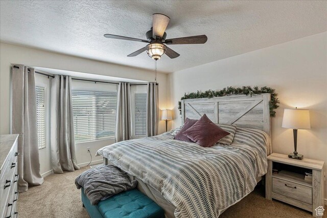 6403 W Muzzle Loader Dr, Herriman, UT 84096 - bedroom featuring light carpet, a ceiling fan, baseboards, and a textured ceiling