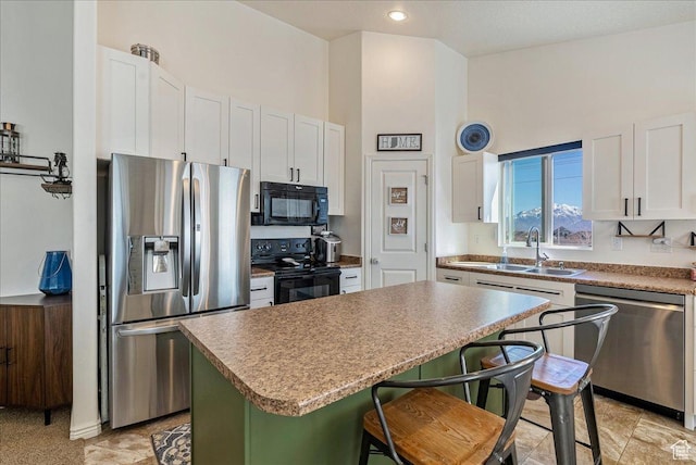 6403 W Muzzle Loader Dr, Herriman, UT 84096 - kitchen with a center island, a sink, black appliances, a breakfast bar area, and white cabinets