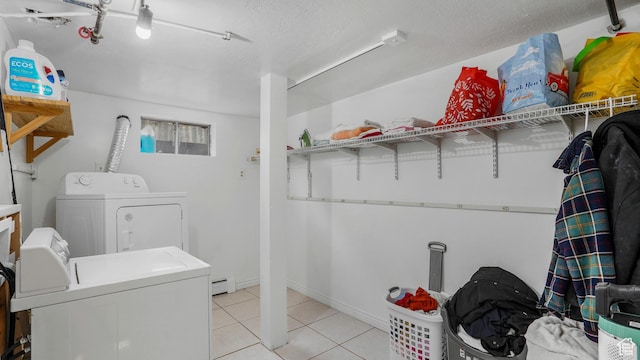 4535 S Ridgeline Dr, Ogden, UT 84405 - clothes washing area featuring light tile patterned flooring, washing machine and clothes dryer, a textured ceiling, baseboard heating, and laundry area