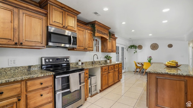 4535 S Ridgeline Dr, Ogden, UT 84405 - kitchen with a sink, stainless steel appliances, brown cabinetry, and light tile patterned floors