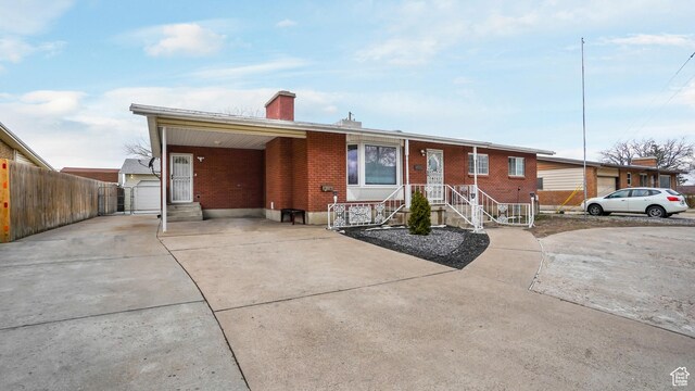 4535 S Ridgeline Dr, Ogden, UT 84405 - single story home featuring concrete driveway, a chimney, fence, brick siding, and a garage