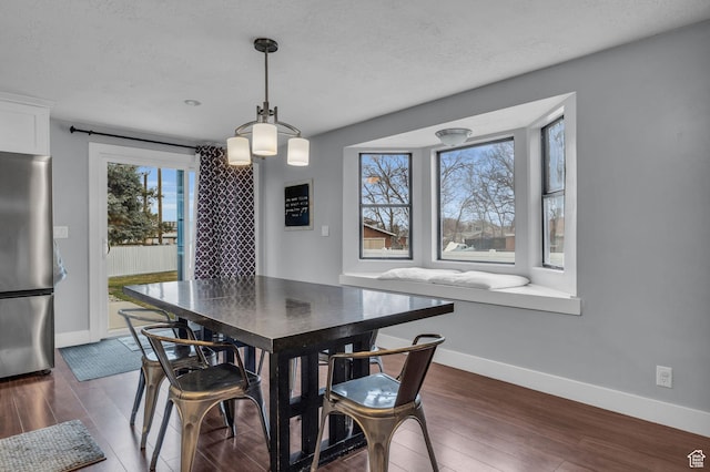175 E Millerberg Dr S, Sandy, UT 84070 - dining area featuring dark wood-style flooring, baseboards, and a textured ceiling