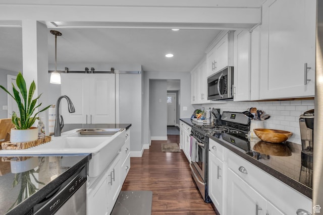 175 E Millerberg Dr S, Sandy, UT 84070 - kitchen with white cabinetry, tasteful backsplash, dark wood-type flooring, a sink, and appliances with stainless steel finishes