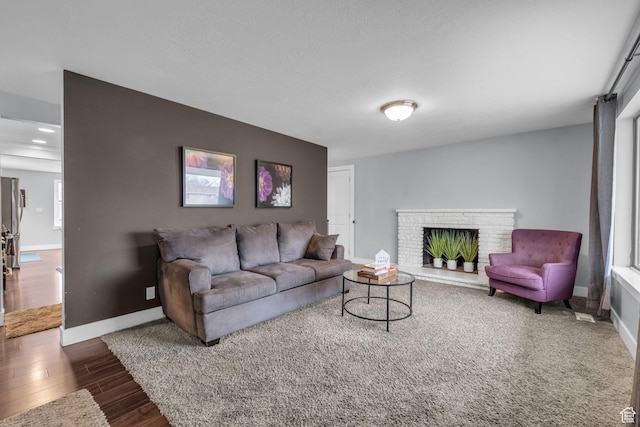 175 E Millerberg Dr S, Sandy, UT 84070 - living area featuring baseboards, wood finished floors, and a brick fireplace