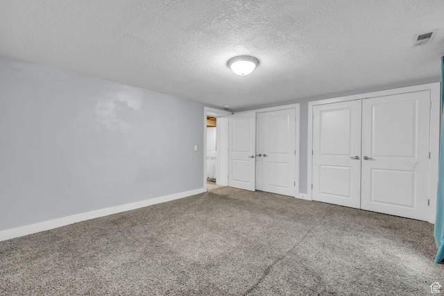 175 E Millerberg Dr S, Sandy, UT 84070 - unfurnished bedroom with carpet floors, a textured ceiling, baseboards, visible vents, and two closets