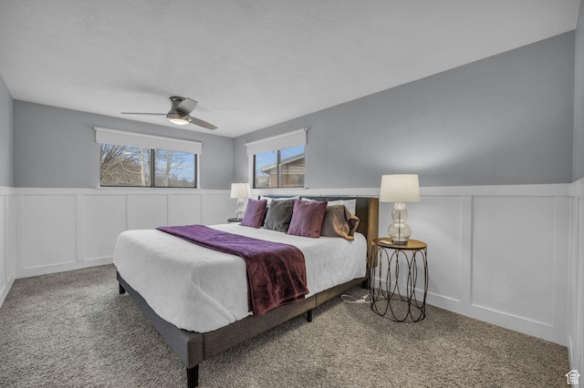175 E Millerberg Dr S, Sandy, UT 84070 - carpeted bedroom with a decorative wall, wainscoting, multiple windows, and ceiling fan