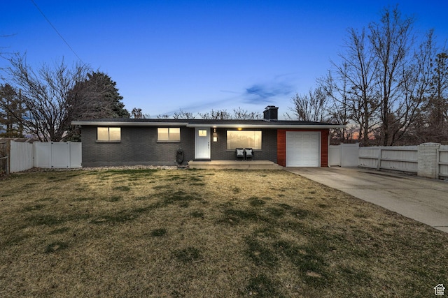 view of front of property featuring fence, a gate, a garage, and brick siding