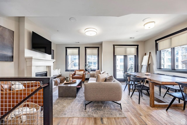 3788 Blackstone Dr Unit 19, Park City, UT 84098 - living room with a glass covered fireplace, light wood finished floors, and visible vents