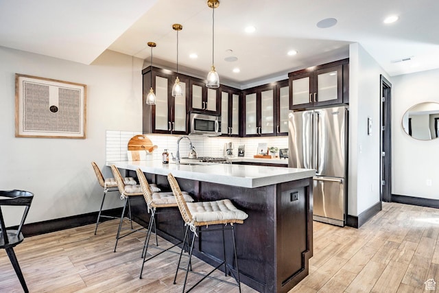 3788 Blackstone Dr Unit 19, Park City, UT 84098 - kitchen with backsplash, light wood-type flooring, glass insert cabinets, and stainless steel appliances
