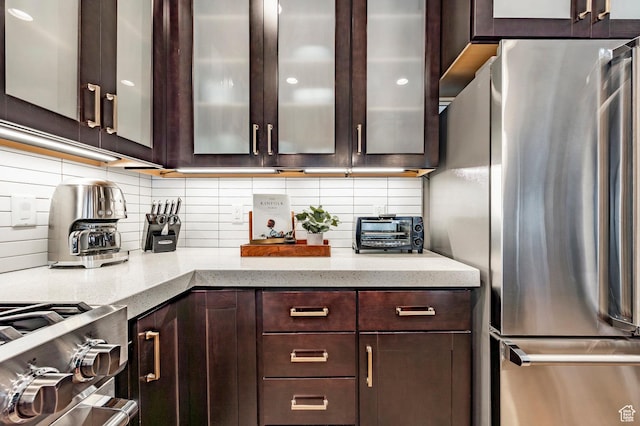 3788 Blackstone Dr Unit 19, Park City, UT 84098 - kitchen featuring freestanding refrigerator, dark brown cabinets, backsplash, and glass insert cabinets