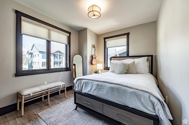 3788 Blackstone Dr Unit 19, Park City, UT 84098 - bedroom featuring multiple windows, baseboards, and wood finished floors