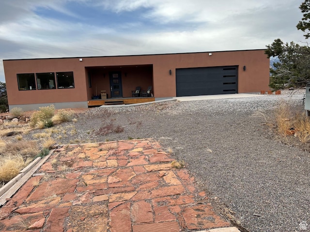 405 W 1000 N, Torrey, UT 84775 - view of front of house featuring driveway, stucco siding, and a garage