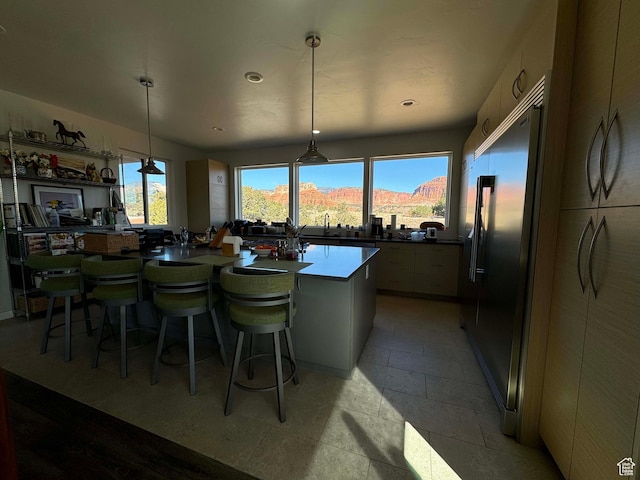 405 W 1000 N, Torrey, UT 84775 - kitchen with a kitchen breakfast bar, hanging light fixtures, built in fridge, and a healthy amount of sunlight