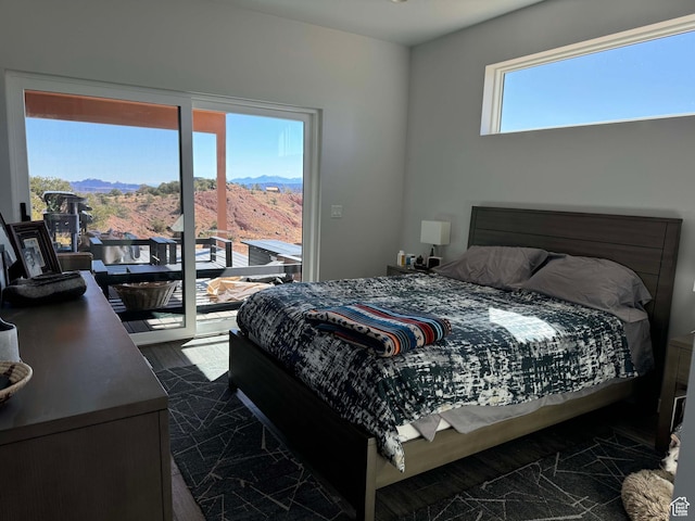 405 W 1000 N, Torrey, UT 84775 - bedroom with dark wood-style floors, a mountain view, and access to outside