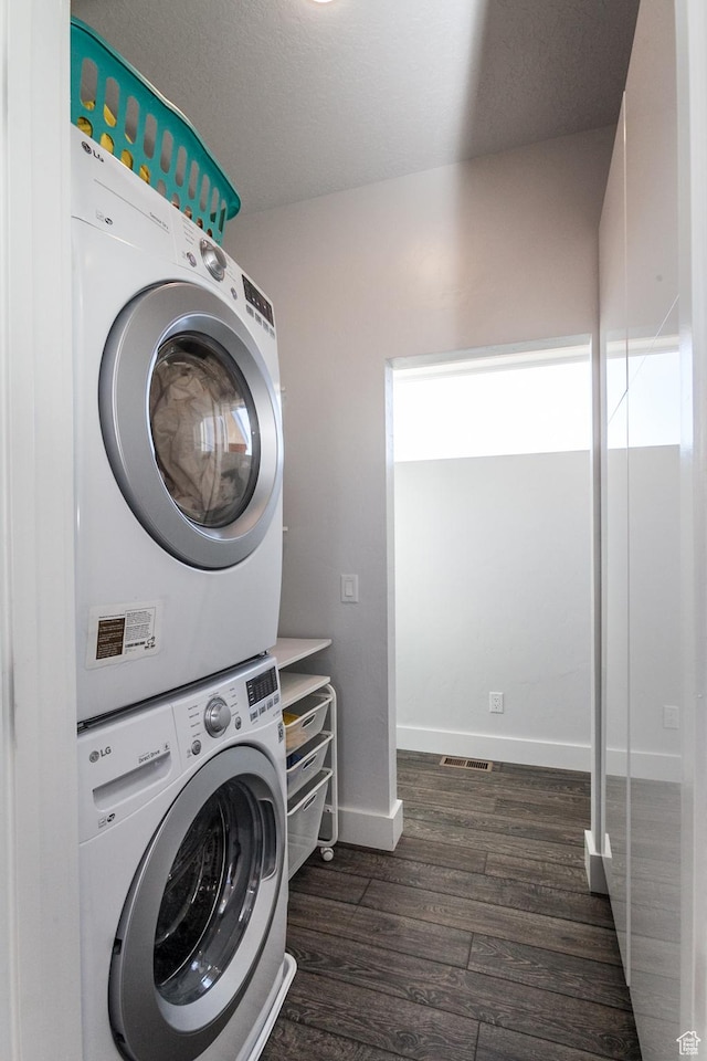 405 W 1000 N, Torrey, UT 84775 - clothes washing area with stacked washer and dryer, baseboards, laundry area, and dark wood-type flooring