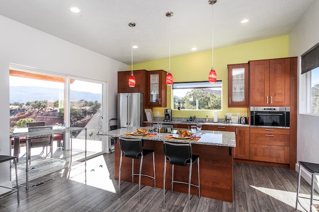 405 W 1000 N, Torrey, UT 84775 - kitchen featuring dark wood-style floors, a center island, appliances with stainless steel finishes, and a breakfast bar