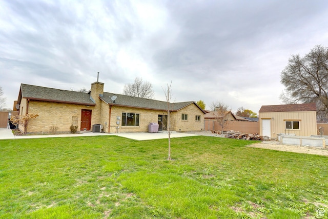 410 N 250 W, Springville, UT 84663 - rear view of property featuring an outdoor structure, fence, a lawn, a patio area, and a chimney