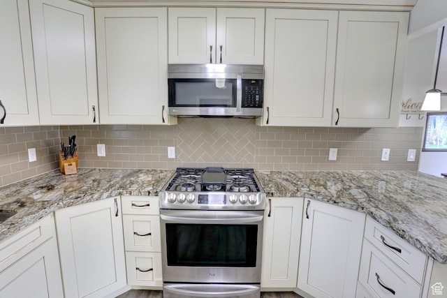410 N 250 W, Springville, UT 84663 - kitchen with light stone counters, decorative backsplash, appliances with stainless steel finishes, and white cabinets