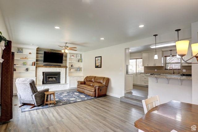 410 N 250 W, Springville, UT 84663 - living area featuring light wood-style flooring, recessed lighting, baseboards, a large fireplace, and a ceiling fan
