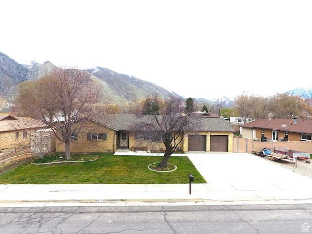410 N 250 W, Springville, UT 84663 - single story home featuring concrete driveway, an attached garage, fence, a front lawn, and a mountain view