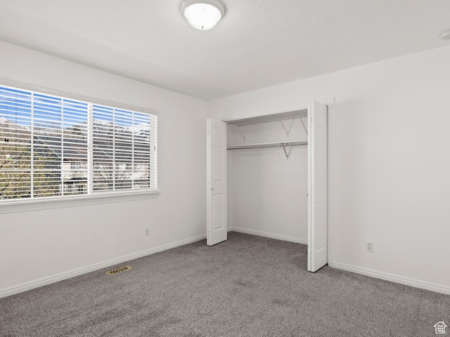 932 Independence Ave, Provo, UT 84604 - unfurnished bedroom with baseboards, visible vents, a closet, and carpet