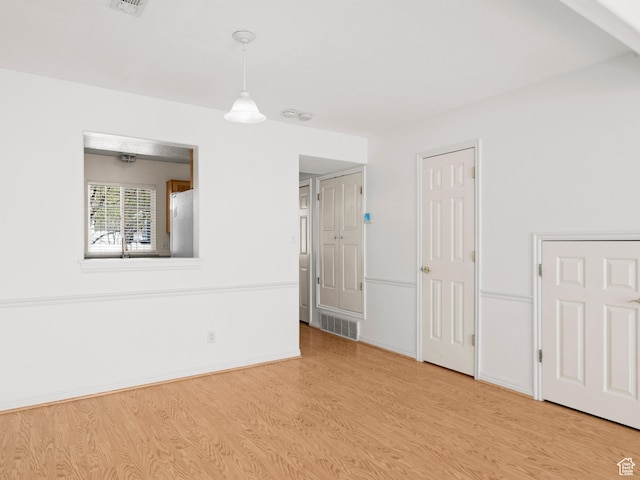 932 Independence Ave, Provo, UT 84604 - unfurnished room with baseboards, visible vents, and light wood-style flooring